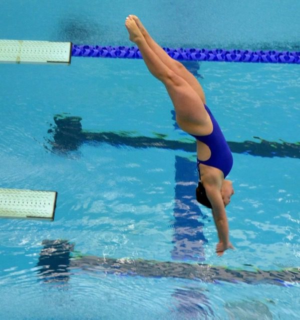 Competitive team diver performing a back entry during team training in San Antonio